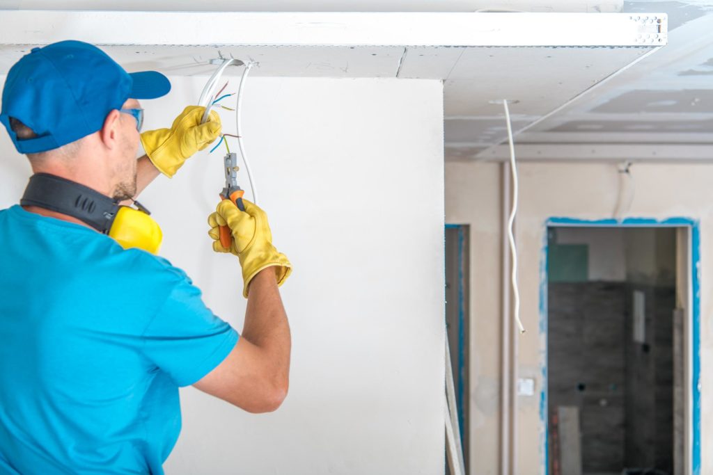 man cutting the electrical wire