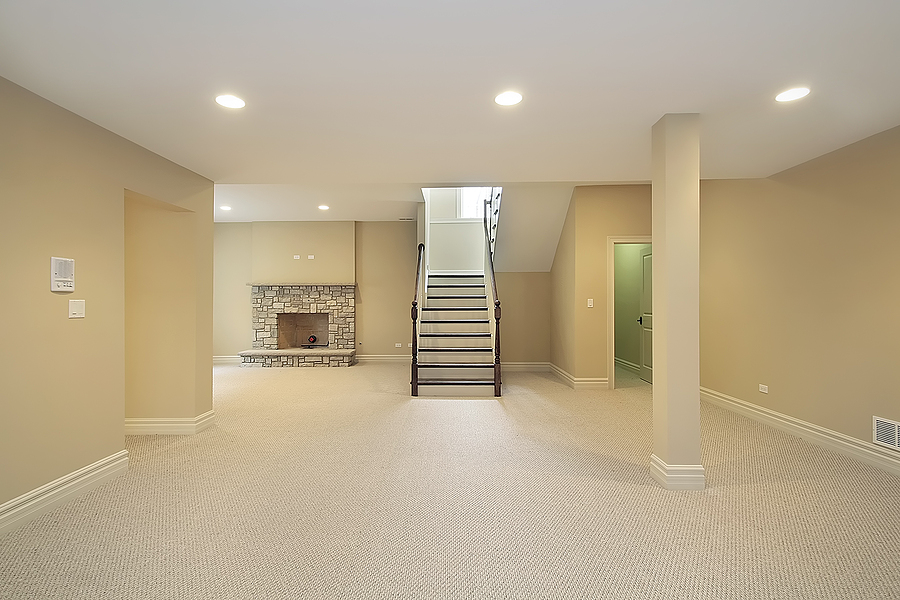 basement in new construction home with stone fireplace