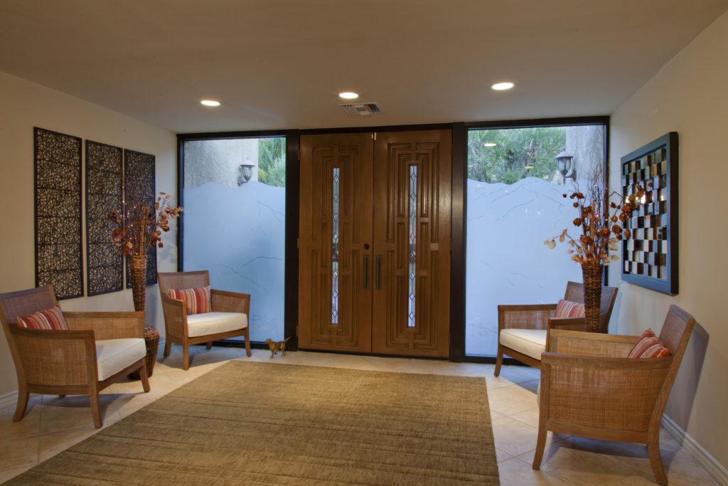 a living room with carpet ng sofa chair