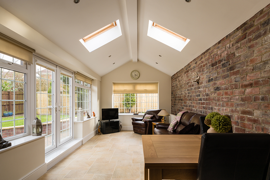 modern sunroom or conservatory extending into the garden with a featured brick wall